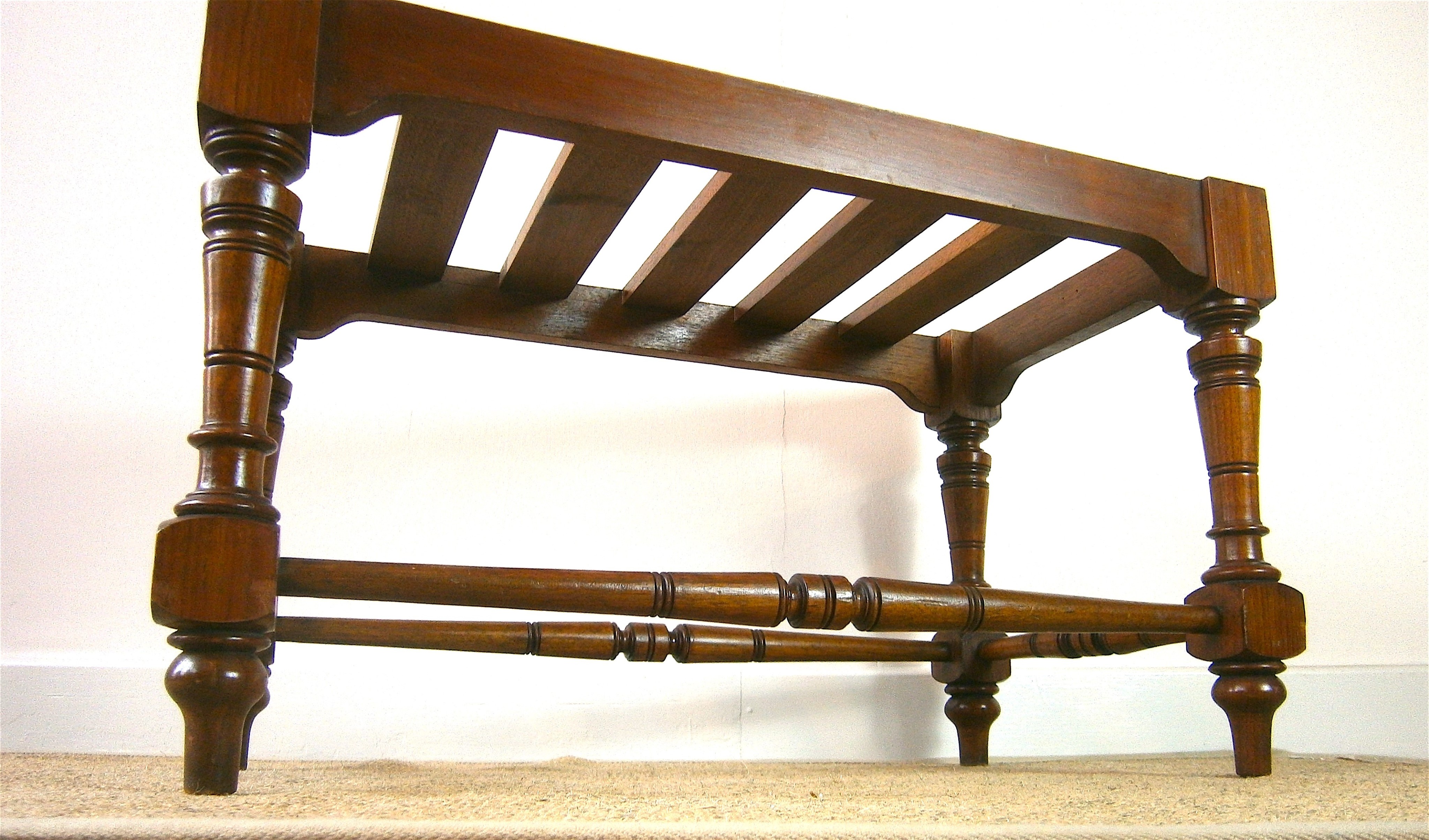 A late Victorian aesthetic movement walnut luggage stand, length 69cm, depth 38cm, height 41cm